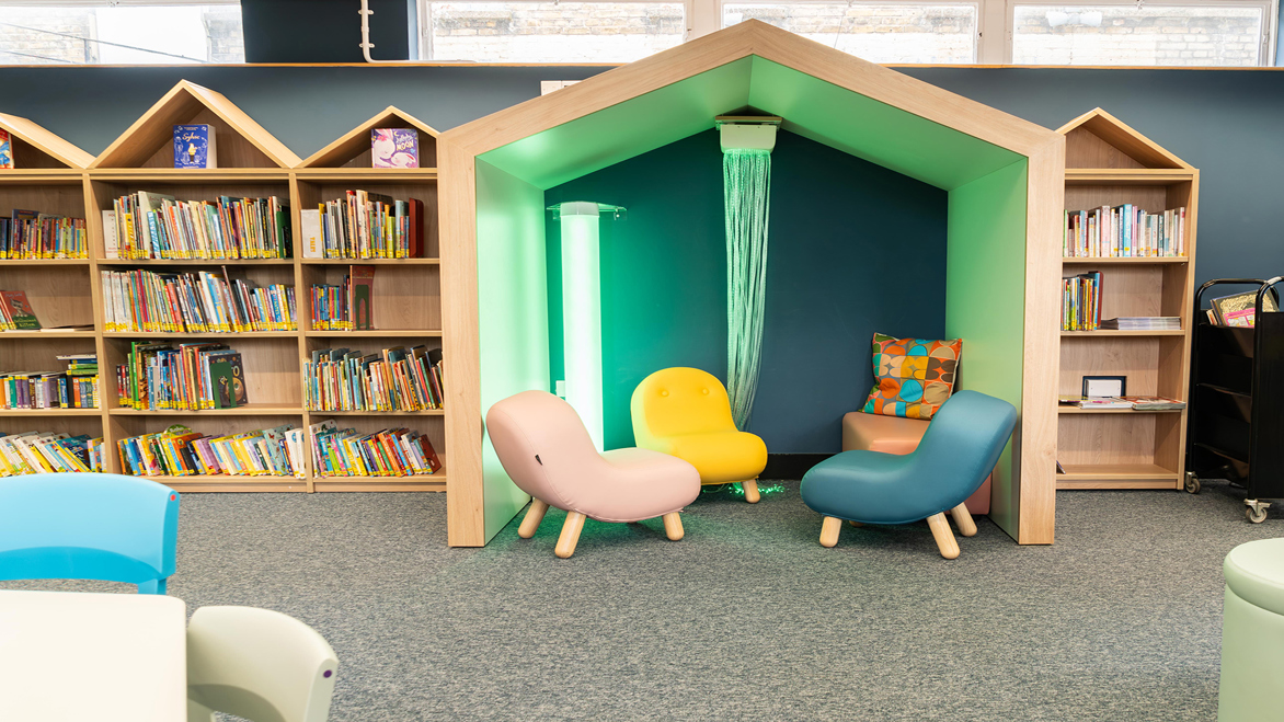 Fun bright green wooden reading alcove in the children's library
