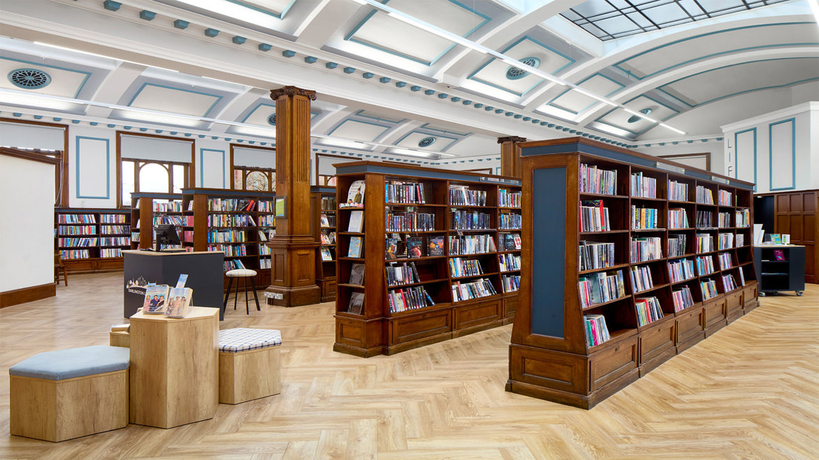 Darlington Library bright interior full dark wooden bookshelves