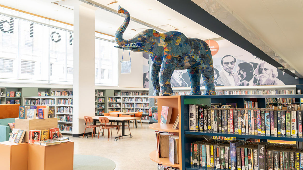 View of the elephant art sculpture inside the library near the bookshelves