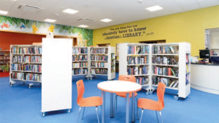 Mountain Ash Library general reading area with table and chairs