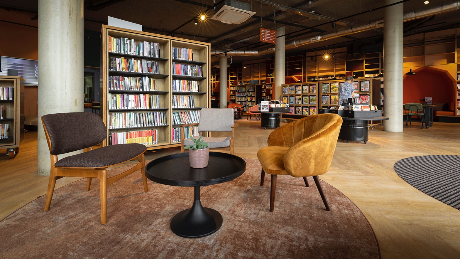 Seating area next to bookshelves at Uithoorn Library