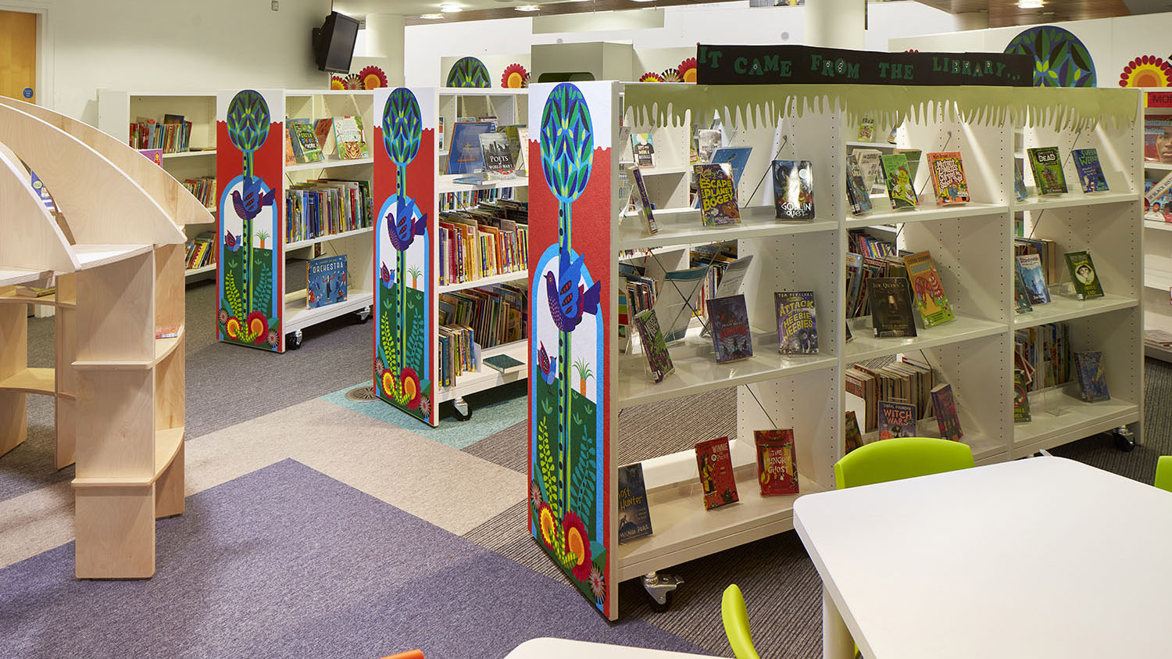 A bright children's library area full of decorative bookshelves for young people in Eltham public library