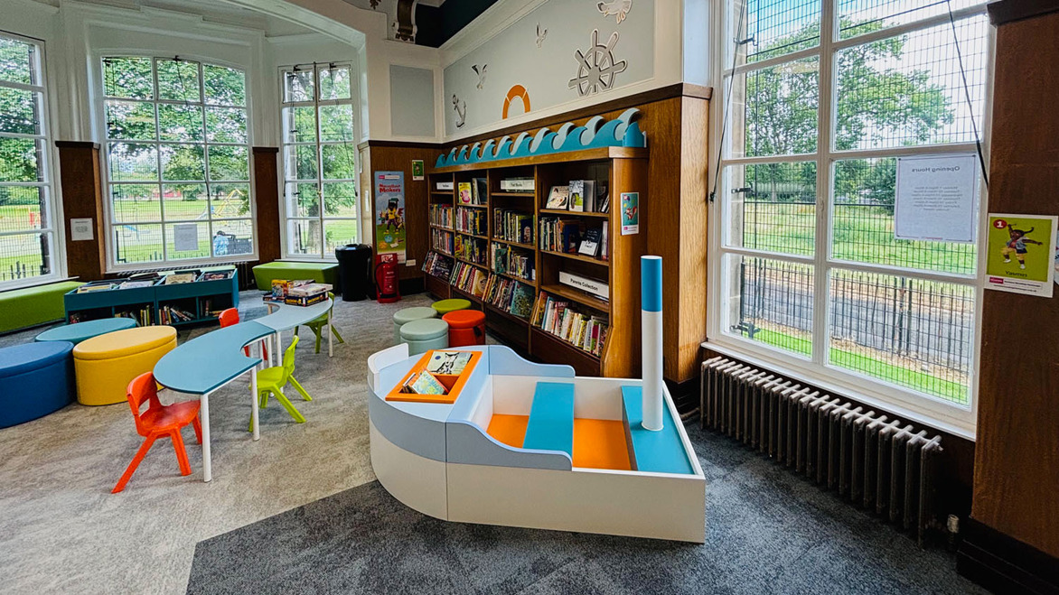 Fun looking colourful book boat and seating area, as seen in Elder Park children's library