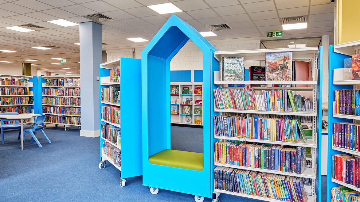 Children's area in Worthing library with bright blue seating arch