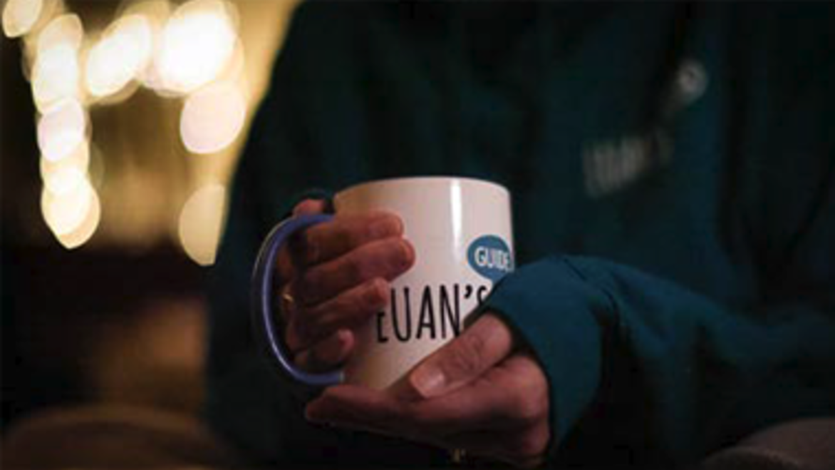 A person holding a cup of tea