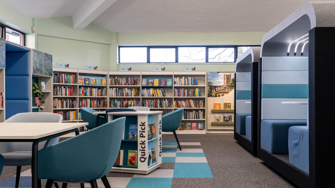 Interior bright public area with cosy reading alcoves and bookshelves