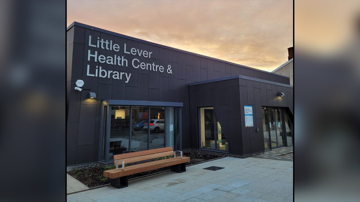 Exterior photograph of Little Lever Library set against a dusky evening sky