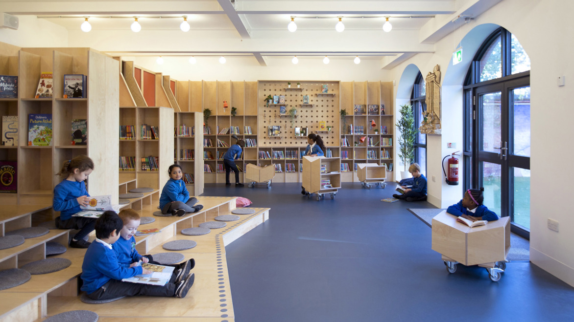 Thornhill School Library with children reading in a well lit room near the entrance